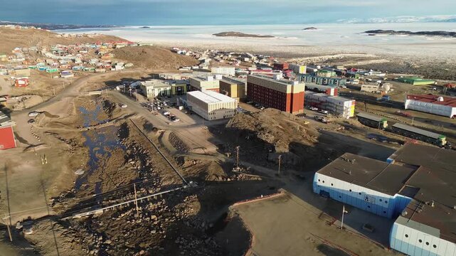 Mid-range aerial view of central public infrastructure in Iqaluit, including the high school, local roads, the Astro Hill Complex, and the iconic Frobisher Inn.