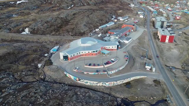 High-angle drone overview of the Qikiqtani General Hospital complex in Iqaluit, Nunavut, serving as the primary healthcare hub for the Baffin Region.