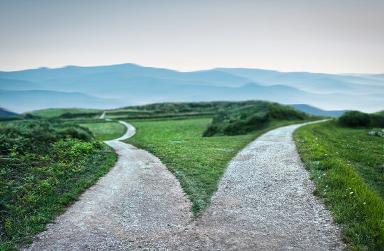 landscape of a fork in the road at storm weather, concept of insecurity of future