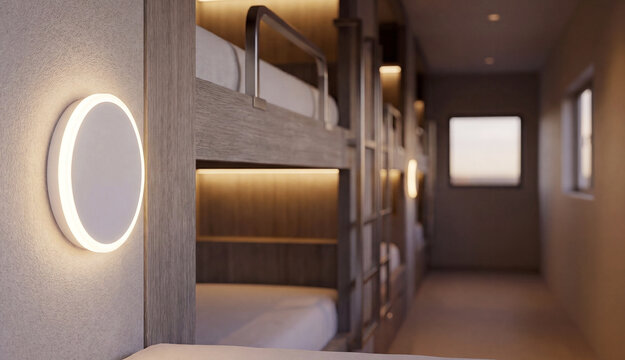 Contemporary round wall light beside hostel bunk beds. Modern hospitality interior with warm ambient illumination and comfortable shared accommodation.