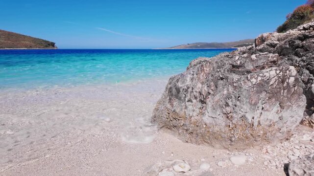 Coastal Rocky Shore In Front Of Transparent Turquoise Sea Under Blue Sky, Himare - Albania.