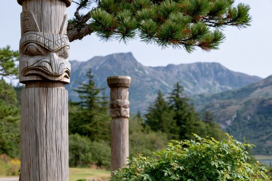 Traditional Tlingit totem pole art in Alaska landscape