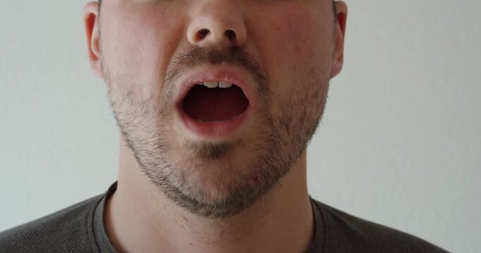 Man touching his jaw and face while experiencing discomfort in the jaw area. Suitable for dental problems, jaw tension, TMJ disorders, toothache, and healthcare concepts.
