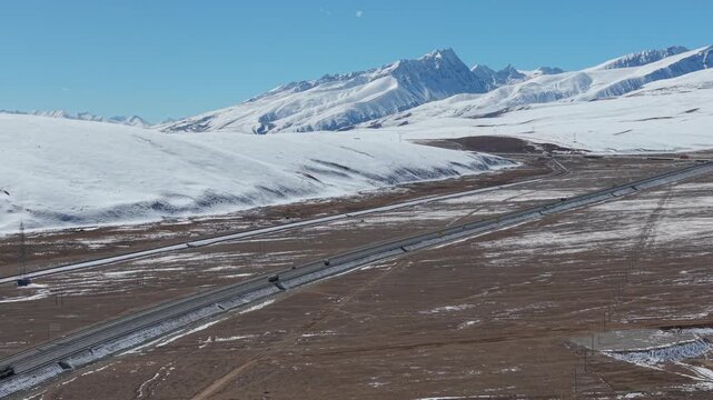 Drone Flyover of Expressway Beneath the Nyainq&ecirc;ntanglha Mountains, Tibet