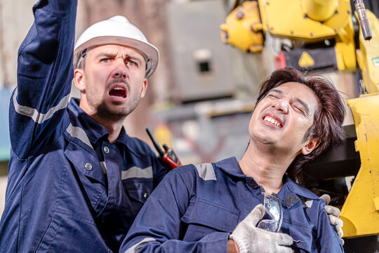 Closeup industrial worker receiving assistance after medical condition flares up from workmate