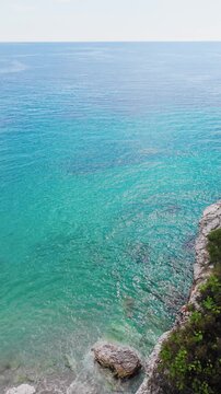 Vertical Aerial View Of Transparent Turquoise Ocean Water Near Coastal Cliff, Himare - Albania.