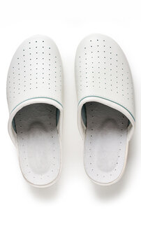 A pair of white professional ventilated work clogs isolated over white