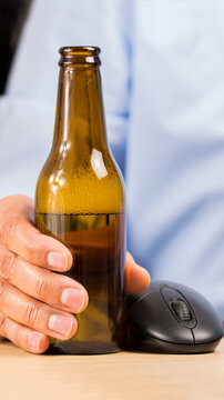 and of a businessman in the office drinking a bottle of beer