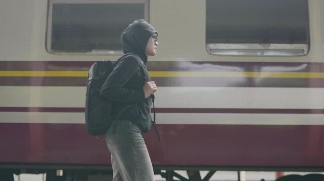 Train travel experience young traveler at railway station digital nomad journey urban environment engaging viewpoint
