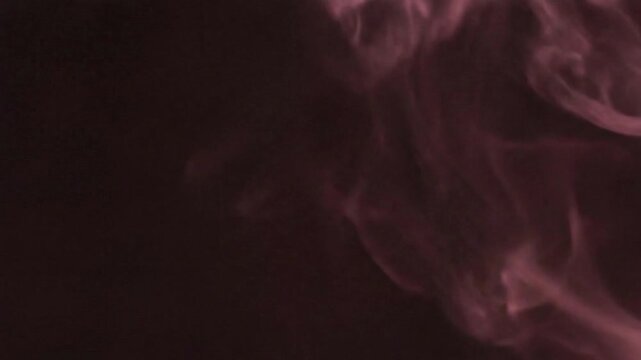 Ethereal pink smoke wisps on black background, cinematic rose colored vapor trails, abstract swirling mist for creative overlays and transitions