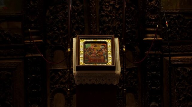 Static shot of an ancient orthodox liturgical book decorated with religious icons inside a historic monastery in Meteora, Greece. Sacred Christian heritage