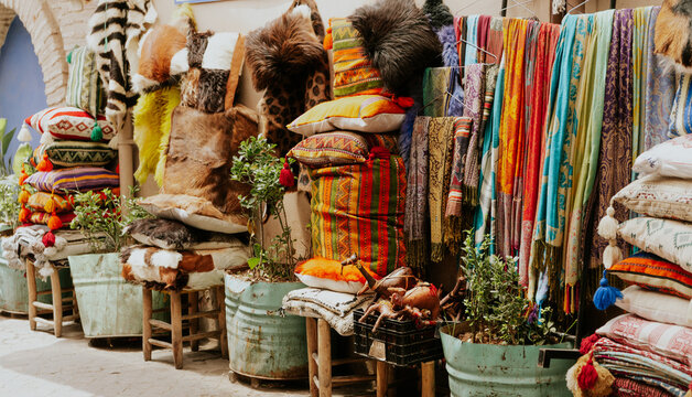 traditional Moroccan craftsmanship with colorful tufted pillows and woven blankets in Marrakech zouk, colorful textile