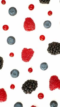 Mixed berries scattered white background flatlay raspberry blueberry blackberry redcurrant minimal food photography slow motion pattern healthy organic studio summer clean design