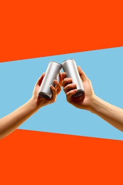 Two blank silver aluminum cans clink in hands against orange and blue geometric background. Concept of beverage toast, party promo, packaging mockup, and drinks campaign.
