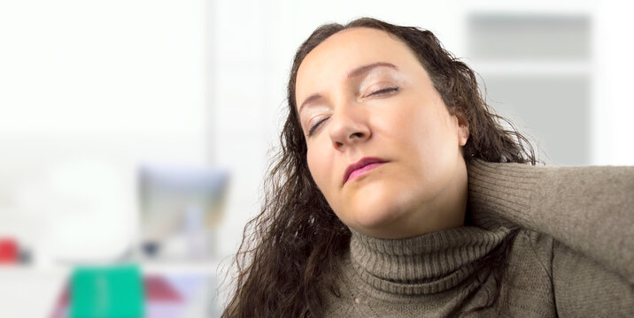 Business woman, neck pain with overtime, creative agency and burnout for night brainstorming. Girl, brand consultant with posture, issue and office muscle strain