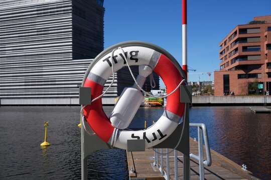 OSLO, NORWAY - MAY 6, 2026: Tryg lifebelt by the water of Bispevika bay in Oslo, Norway. Tryg Forsikring insurance company has installed over 50,000 public lifebelts in Norway since 1950s.