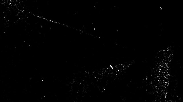 Abstract grunge dirty monochrome background. Scratched damaged dynamic overlay texture surface in trendy vintage stop motion style. Seamless loop animation.
