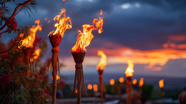 Burning bamboo torches at sunset against moody cloudy sky with outdoors
