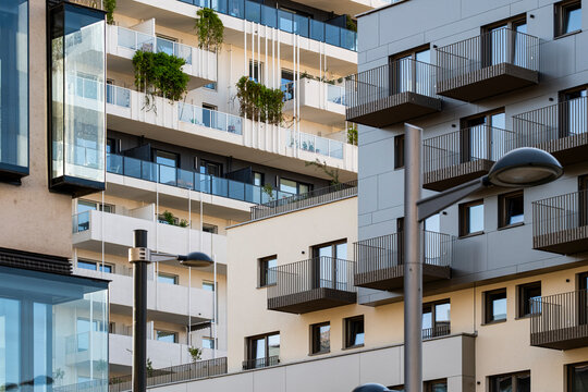apartment buildings overlap in Nordbahnviertel Vienna Austria as balconies glass facade windows and a street lamp layer the surrounding housing blocks