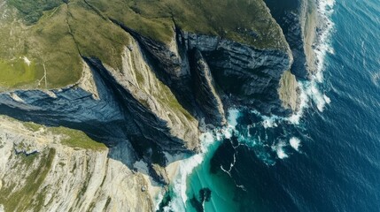 Breathtaking aerial view of giant coastal cliffs with crashing waves and turquoise water below