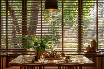 Obraz premium Elegant dining table set for a meal with lush tropical greenery and warm sunlight filtering through blinds