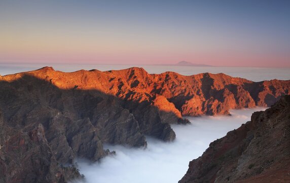 View from the Roque de los Muchachos on the Caldera de Taburiente with cloud cover, behind Tenerife with Teide volcano, Caldera de Taburiente National Park, La Palma, Canary Islands, Spain