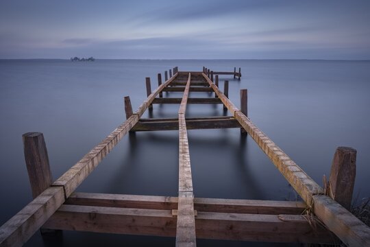 View of a partially dismantled jetty on the Steinhuder Meer, long exposure, Wilhelmstein, Hagenburg Canal, lake, nature photo, landscape photography, drifting clouds, landscape format, wood, Hagenburg, Hanover region, Lower Saxony, Germany