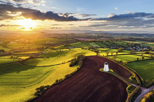 Sunset of Devon Windmill over Fields and Farms from a drone, Torquay, Devon, England, United Kingdom