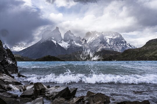 Cuernos del Paine, wind-whipped Lago Peho&eacute; with spray and waves in the foreground, cloudy sky, Torres del Paine National Park, Magallanes region, Patagonia, Chile