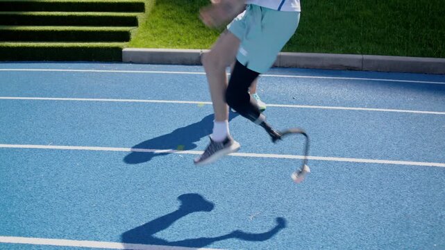 Paraathlete with prosthetic leg raises knees as trainer watches