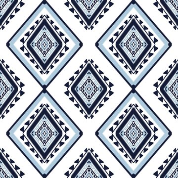 Indigo blue and white ethnic geometric seamless pattern traditional tribal ornaments with diamond shapes and Aztec elements. Vector background for fabric, textile, stationary and cultural design.