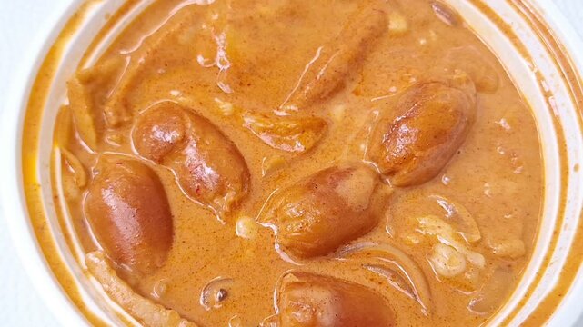 Korean rose tteokbokki rice cakes served in a bowl with a creamy, savory sauce.