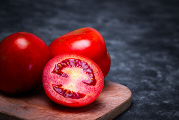 tomatoes on a wooden background © StanleyRevaldo