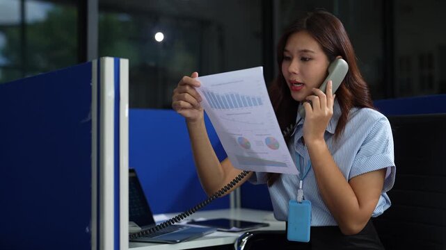 Asian businesswoman involved in cellphone call conversation giving professional consultation to client or negotiating project.