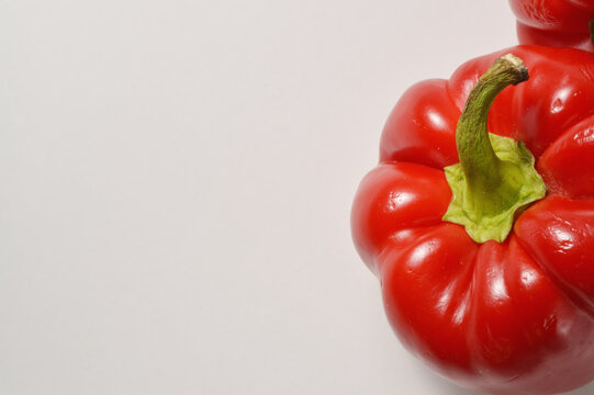 Close up red bell pepper horizontal orientation  border composition against clean white background with generous copy space, red pepper culinaary overlay, pepper photo for branding