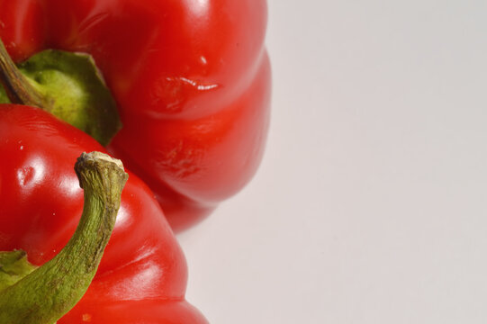 Close up red bell pepper border composition against clean white background with generous copy space, red pepper culinaary overlay, pepper photo for branding