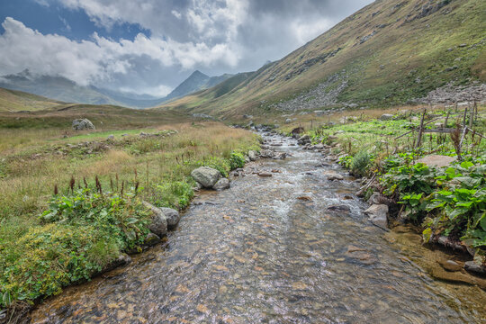 Pristine creek running amidst green slopes in Hacivanak valley, Rize, Turkey