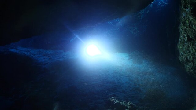 cave diving underwater scuba divers exploring caves and having fun ocean scenery sun beams and rays background