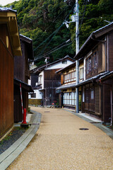 Fototapeta premium Winding asphalt road through traditional wooden houses village in Japan