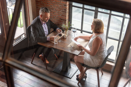 Elegant couple dining together joyfully.