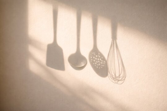 shadow of kitchen utensils on clean wall with strong sunlight