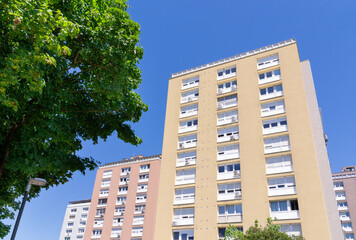 Modern residential apartment buildings under clear blue sky in summer. Multi story block of flats building facade with air conditioners © Yulia Antonova