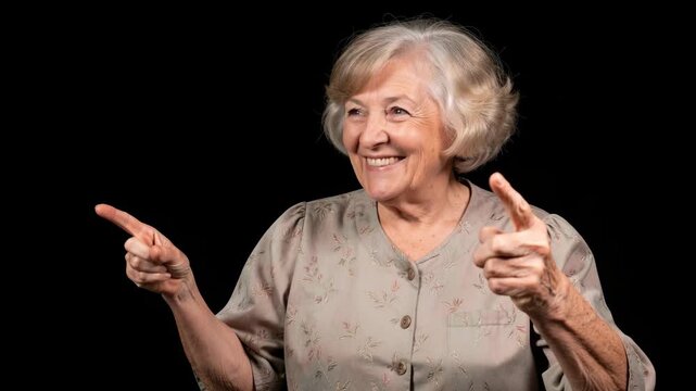 A senior female with a smile and gestures for emphasis.