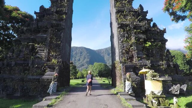 Woman walking through Handara Gate in Bali, Indonesia