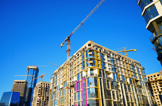 Skyscrapers construction of complex of office and residential elite class. Process of construction of modern skyscraper tower. Real estate market in Europe. Tower crane on construction 