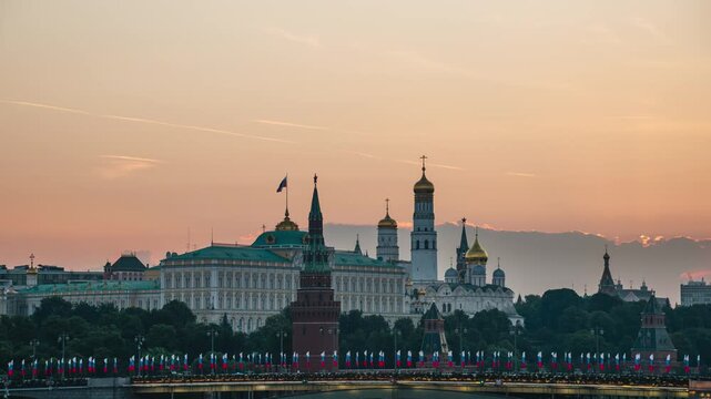 A morning view of the Moscow River, the Kremlin, St. Michael the Archangel's Cathedral, and the Grand Kremlin Palace, with the sun rising over the horizon &mdash; time-lapse photography