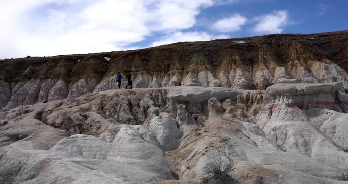 Couple exploring colorful clay formations at Paint Mines Interpretive Park, Colorado