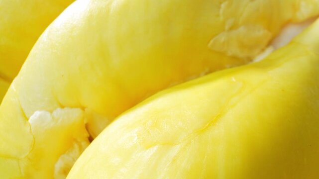 Fresh durian pulp captured in macro detail, featuring creamy layers and rich texture. A delicious tropical ingredient commonly enjoyed in desserts, smoothies, and specialty culinary creations. 4k.
