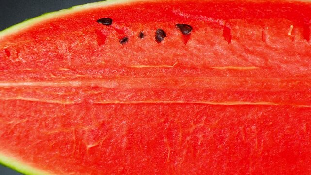 Detailed image of fresh watermelon pulp with bright red coloration and smooth texture, perfect for illustrating healthy fruit ingredients, refreshing desserts, and nutritious meal concepts. 4k.
