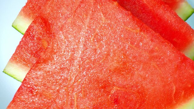 Freshly sliced watermelon displayed with vivid red flesh and pale rind, illustrating premium fruit freshness, summer refreshments, and nutritious food options for wellness-focused content. 4k.
